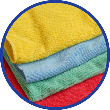 A close up of three different colored towels