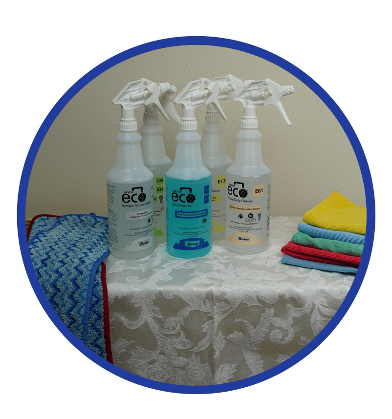 A table with four spray bottles and towels.